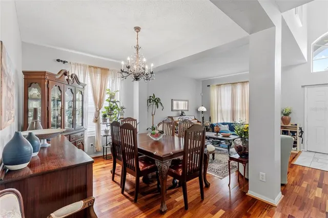 a view of a dining room with furniture window and wooden floor