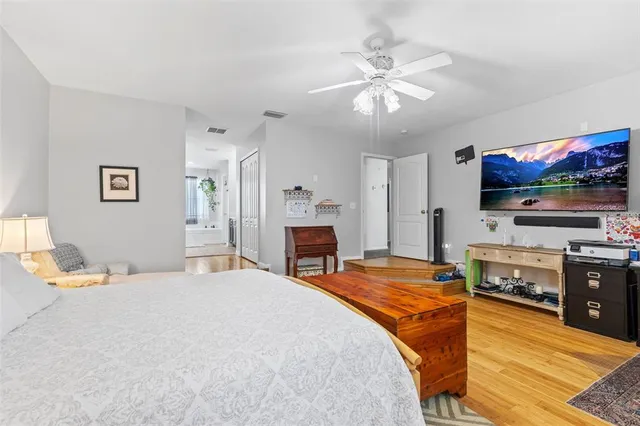 a bathroom with a tub a sink and mirror