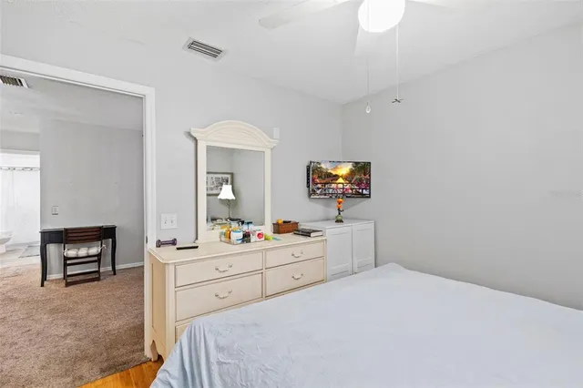 a living room with patio furniture and a potted plant