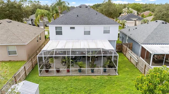 a view of a backyard with floor to ceiling window plants and trees