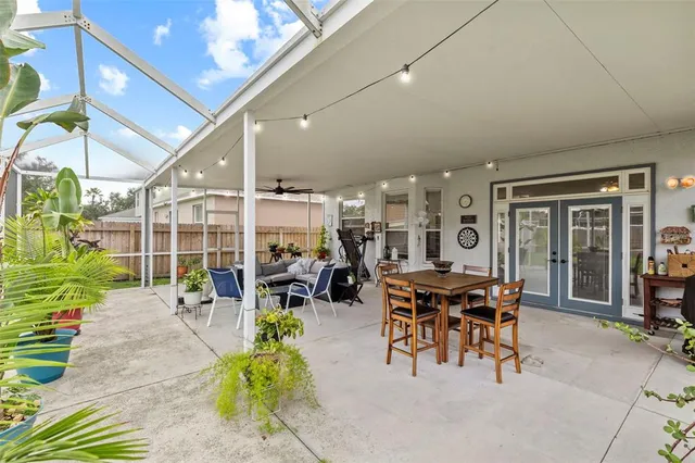 an aerial view of residential houses with outdoor space and trees