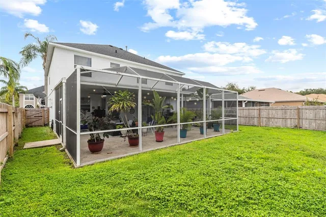 an aerial view of residential houses with outdoor space and parking