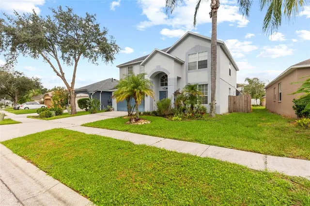 an aerial view of residential houses with outdoor space and parking