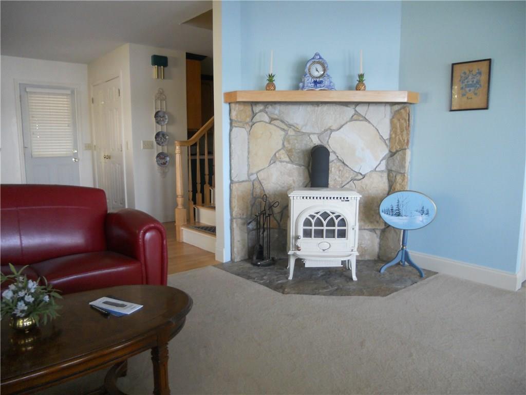 107 Cottage Road Windham, ME 04062 - Photo 9 of 24 Living room with hearth and wood stove.