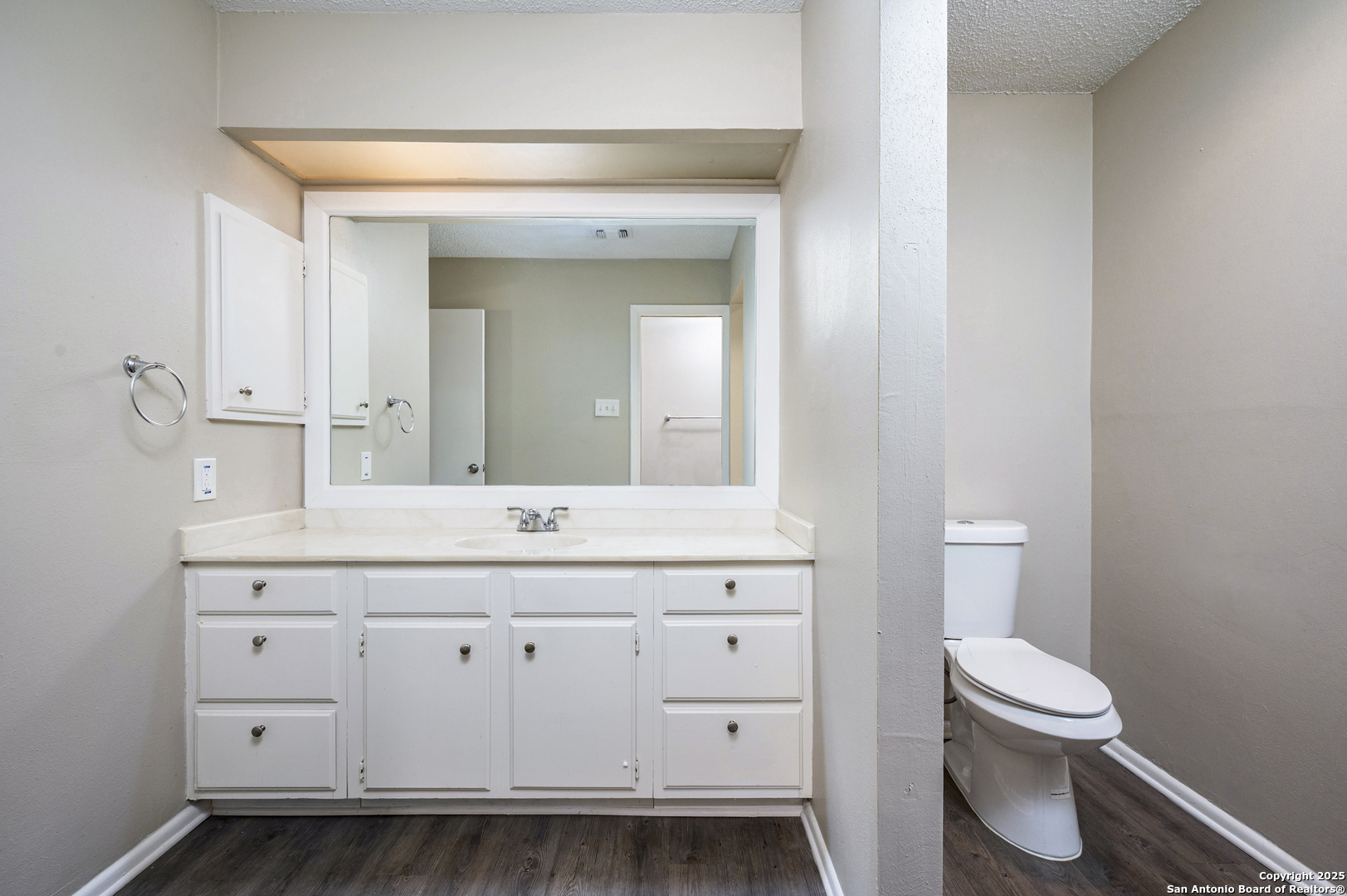1819 Babcock Road, Unit 704 San Antonio, TX 78229 - Photo 19 of 28 a bathroom with a sink a toilet and a mirror