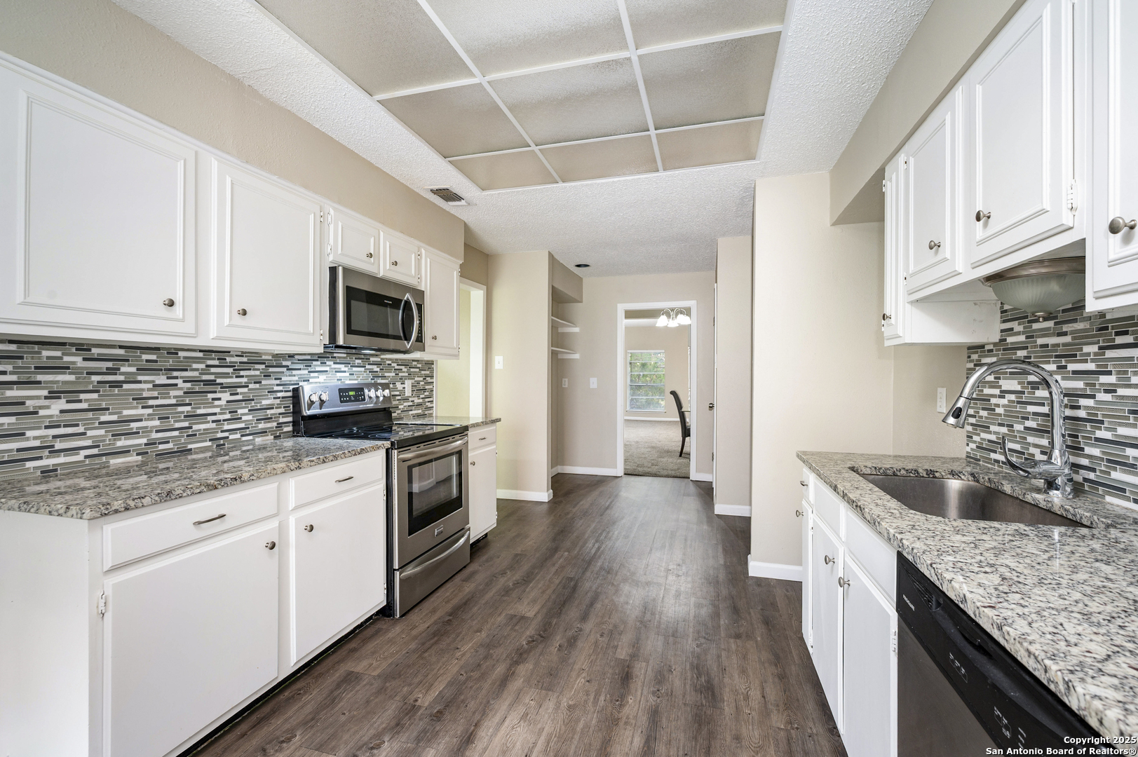 1819 Babcock Road, Unit 704 San Antonio, TX 78229 - Photo 8 of 28 a kitchen with granite countertop a sink a counter space stainless steel appliances and cabinets