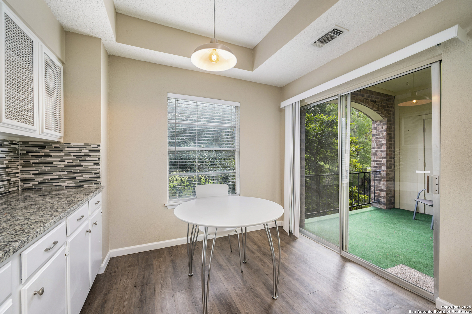1819 Babcock Road, Unit 704 San Antonio, TX 78229 - Photo 10 of 28 a view of a dining room with furniture window and wooden floor