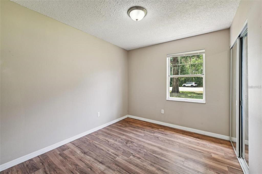 5 Cedar Lane Ocala, FL 34472 - Photo 16 of 23 an empty room with wooden floor and windows
