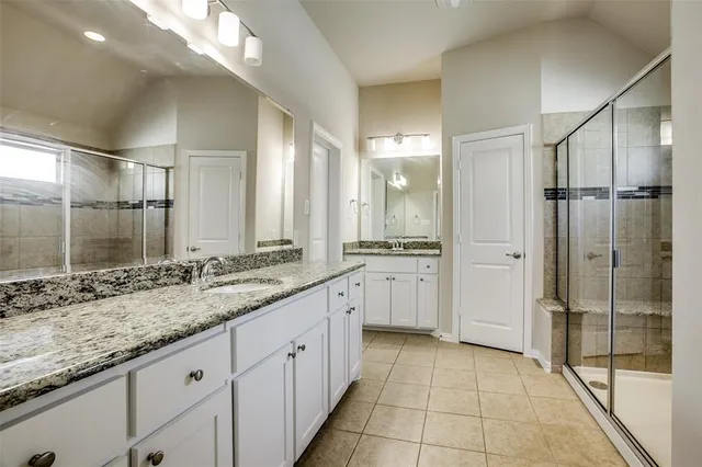 a bathroom with a granite countertop sink mirror and double