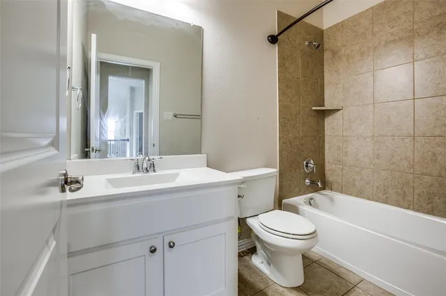 a bathroom with a toilet a sink a mirror a bathtub and shower