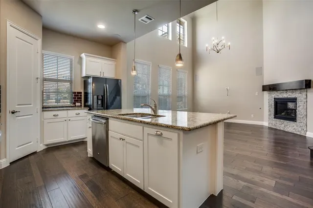 a kitchen with a sink cabinets and wooden floor