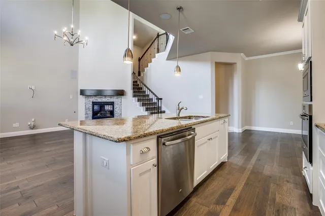 a spacious bathroom with a granite countertop sink a mirror and a vanity