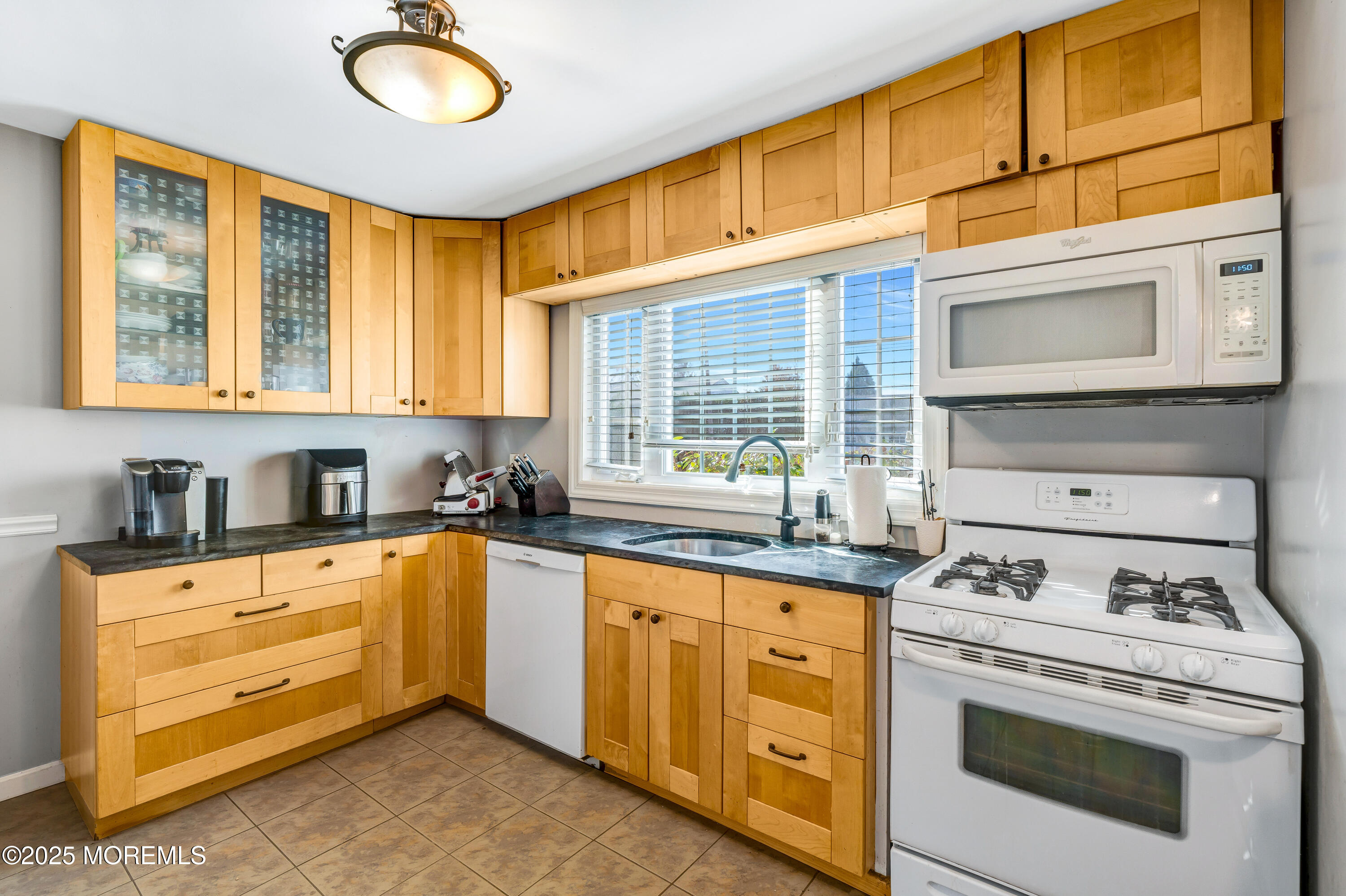 67 Victoria Place Red Bank, NJ 07701 - Photo 15 of 29 a kitchen with stainless steel appliances granite countertop a stove a sink and dishwasher next to a window