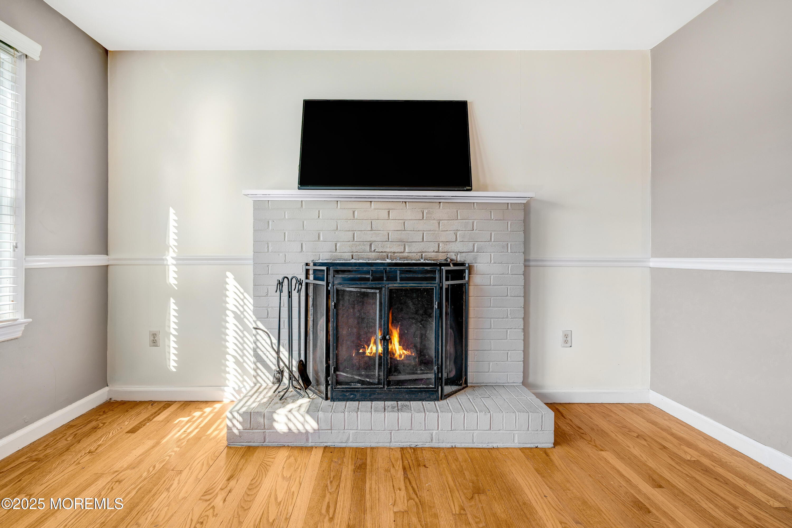 67 Victoria Place Red Bank, NJ 07701 - Photo 10 of 29 a living room with a fireplace and a flat screen tv