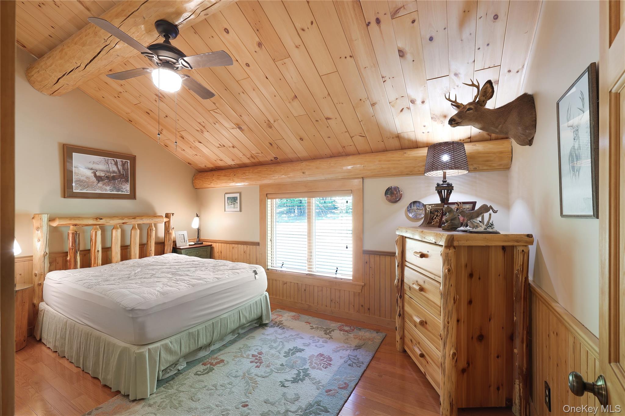 25 Cauthers Road Fallsburg, NY 12789 - Photo 22 of 27 a bedroom with a bed and a chandelier