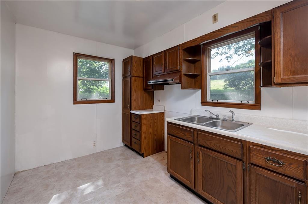 1438 Chicora Road Chicora, PA 16025 - Photo 18 of 25 a kitchen with a sink window and cabinets