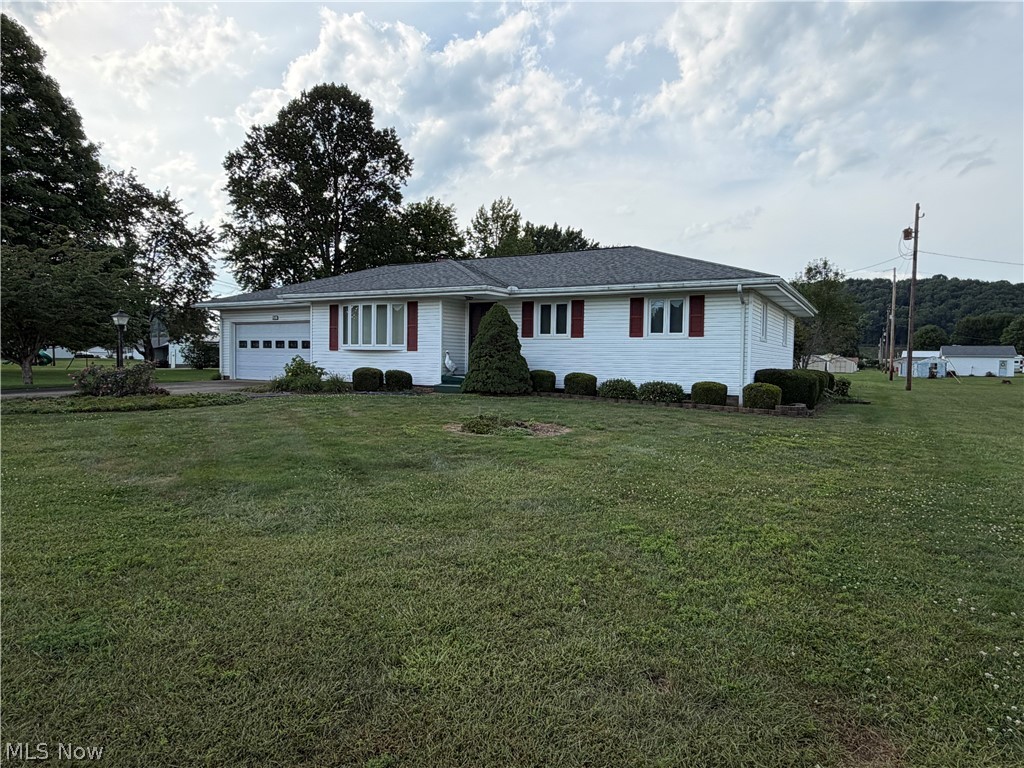 6063 East State Road Newcomerstown, OH 43832 - Photo 27 of 31 White single-story exterior with red window shutters