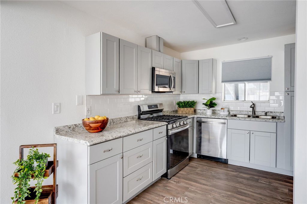 2254 Riverside Drive, Unit 2256 Los Angeles, CA 90039 - Photo 11 of 27 a kitchen with stainless steel appliances granite countertop a sink a stove and cabinets