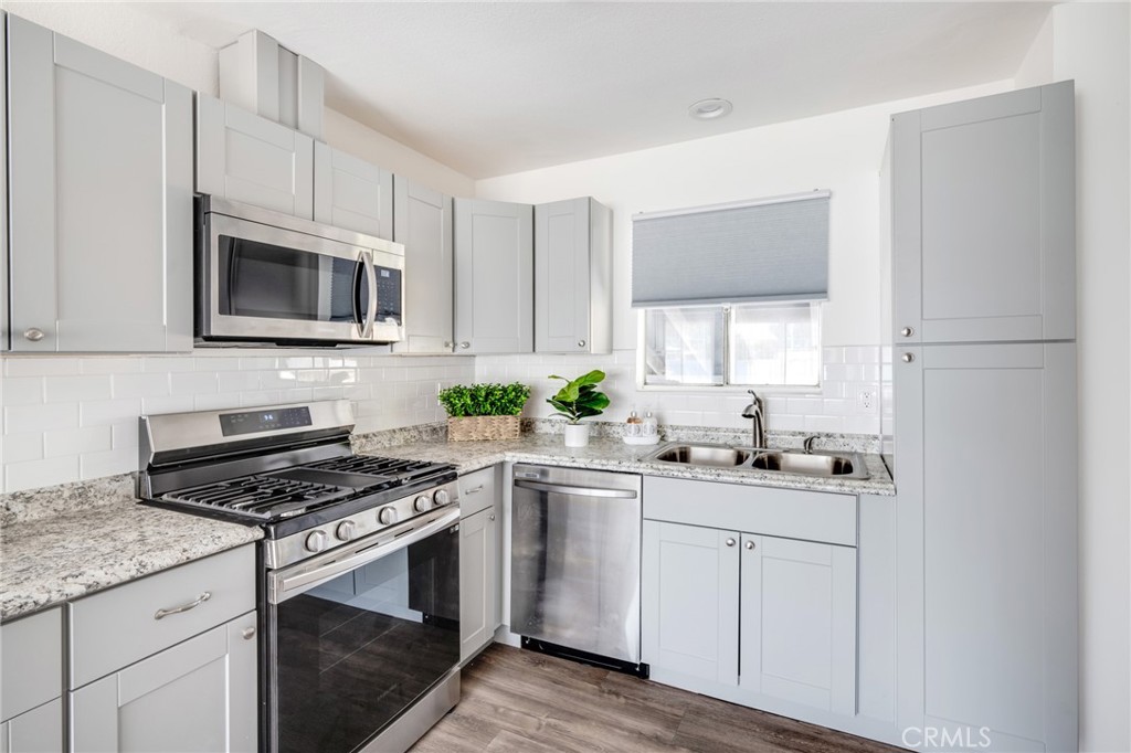 2254 Riverside Drive, Unit 2256 Los Angeles, CA 90039 - Photo 12 of 27 a kitchen with granite countertop a sink stove and cabinets