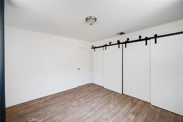 a view of a room with wooden floor