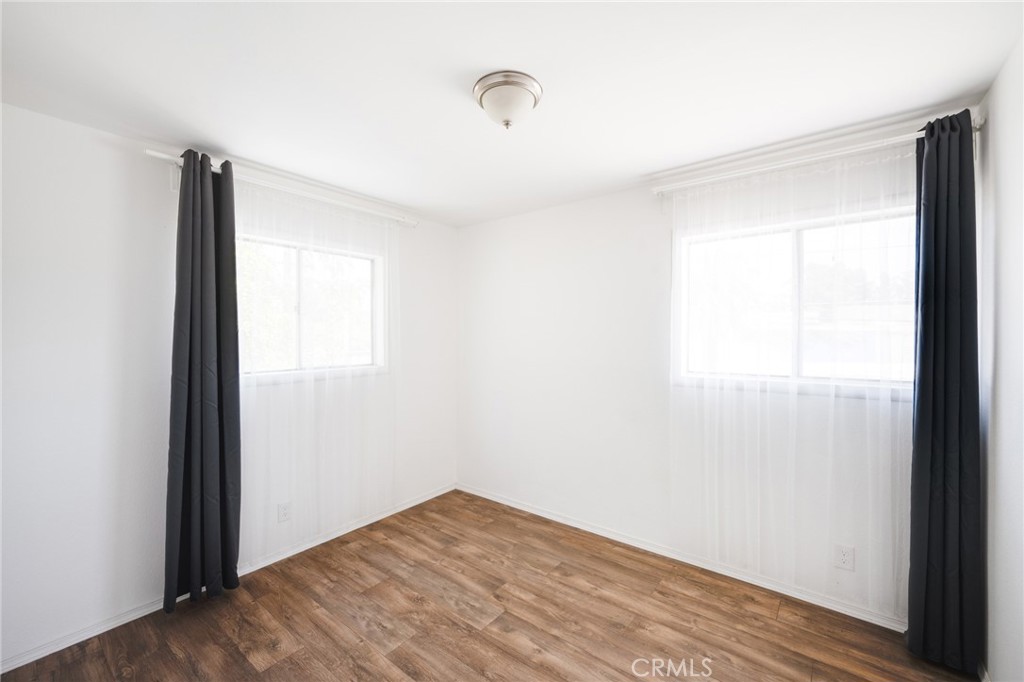 2254 Riverside Drive, Unit 2256 Los Angeles, CA 90039 - Photo 18 of 27 a view of an empty room with wooden floor and a window