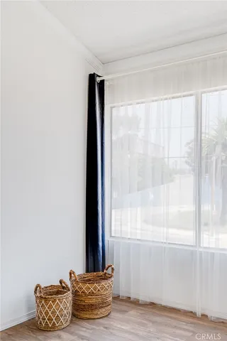 a room with wooden floor and a window