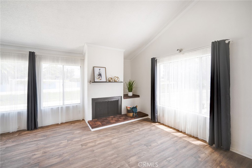 2254 Riverside Drive, Unit 2256 Los Angeles, CA 90039 - Photo 5 of 27 a view of empty room with wooden floor and fireplace
