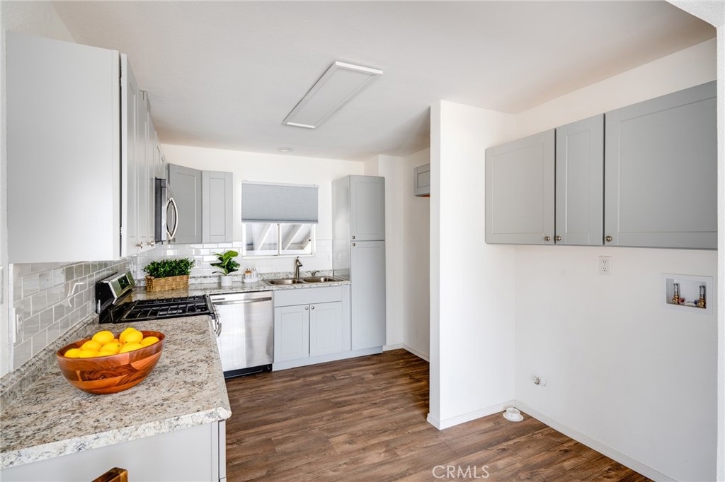 2254 Riverside Drive, Unit 2256 Los Angeles, CA 90039 - Photo 10 of 27 a kitchen with granite countertop a stove a refrigerator and a white cabinets