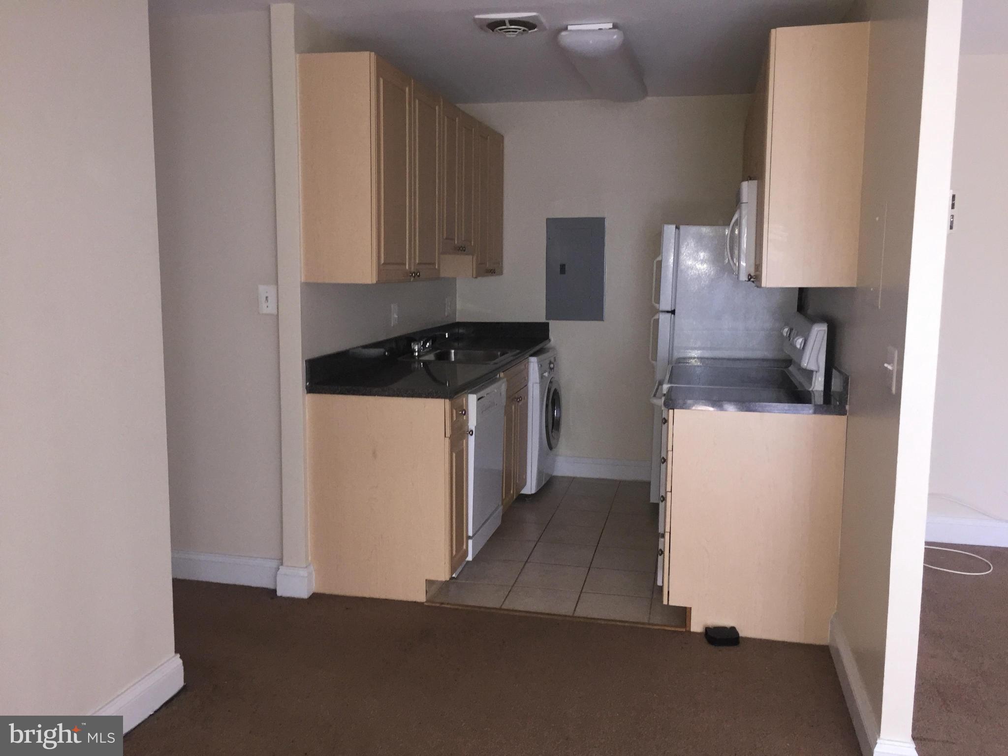 1005 Chillum Road, Unit 302 Hyattsville, MD 20782 - Photo 3 of 7 a kitchen with a sink a stove and a refrigerator