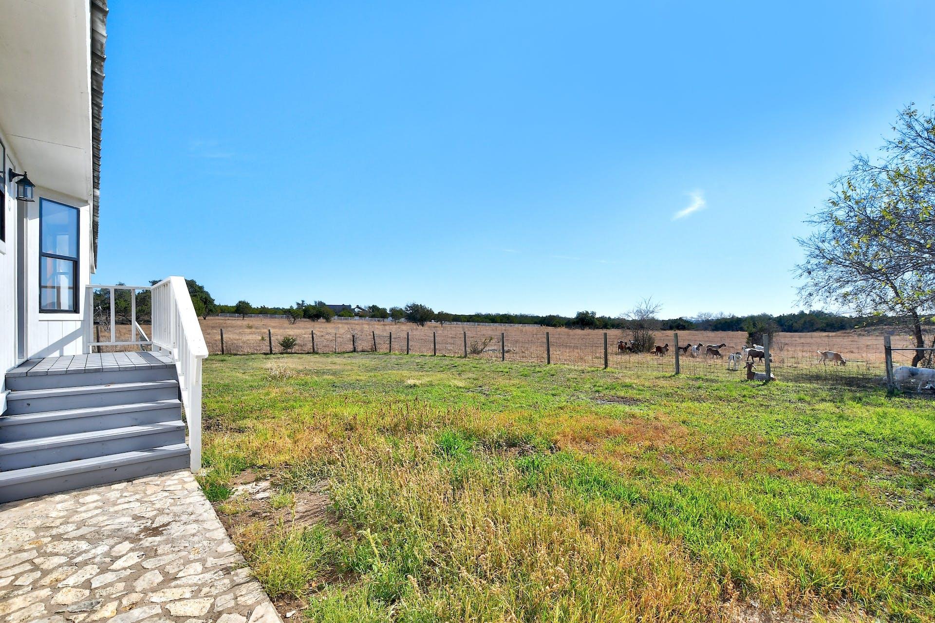 501 Myers Creek Road Dripping Springs, TX 78620 - Photo 25 of 33 Fenced pastures unfold under wide open skies, offering plenty of space for outdoor activity.