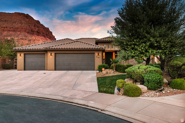 210 Talon Court Ivins, UT 84738 - Photo 46 of 60 View of front of home with a garage, concrete driveway, stucco siding, and a tile roof
