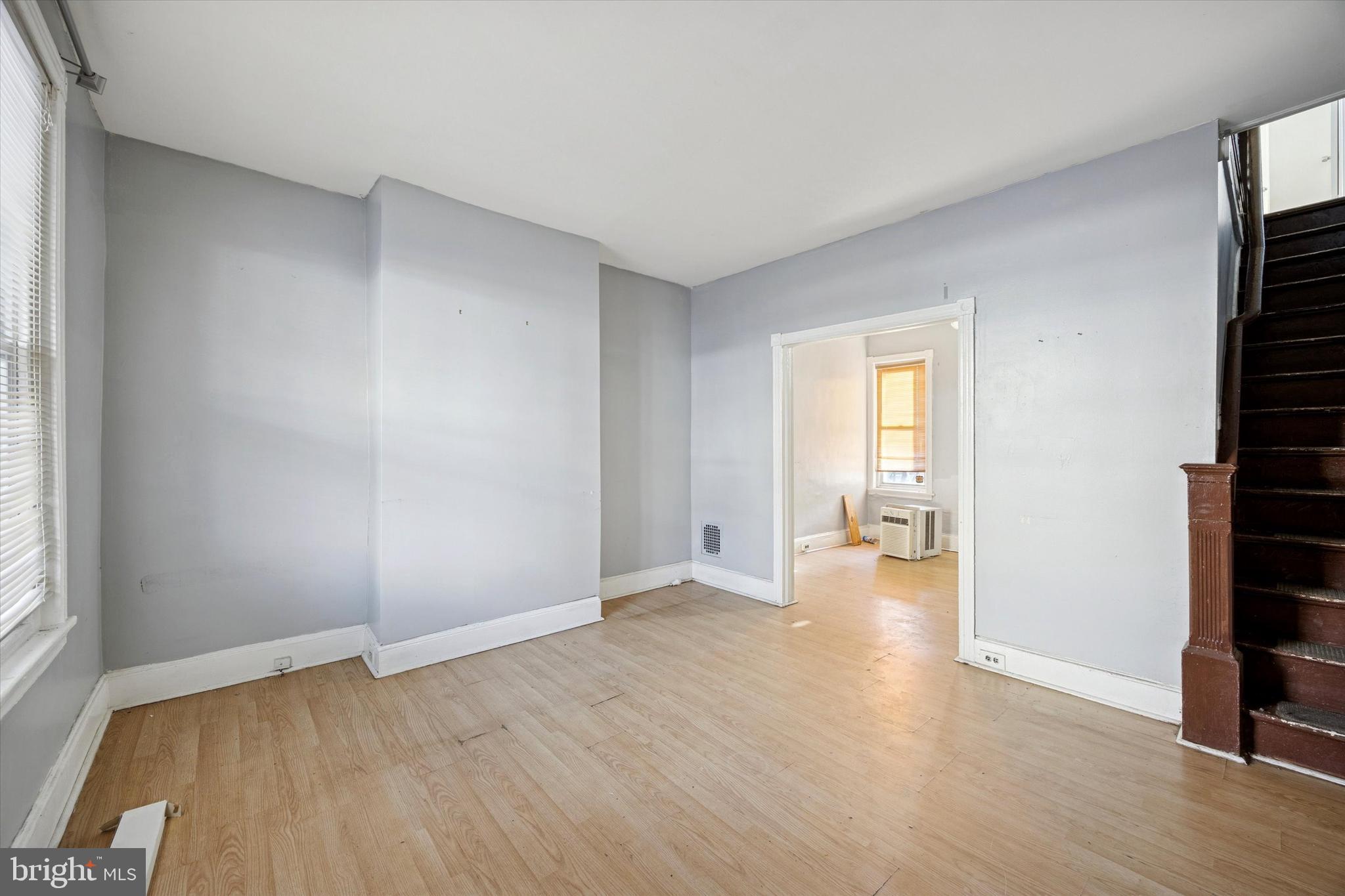 6340 Theodore Street Philadelphia, PA 19142 - Photo 2 of 15 wooden floor in an empty room with a window