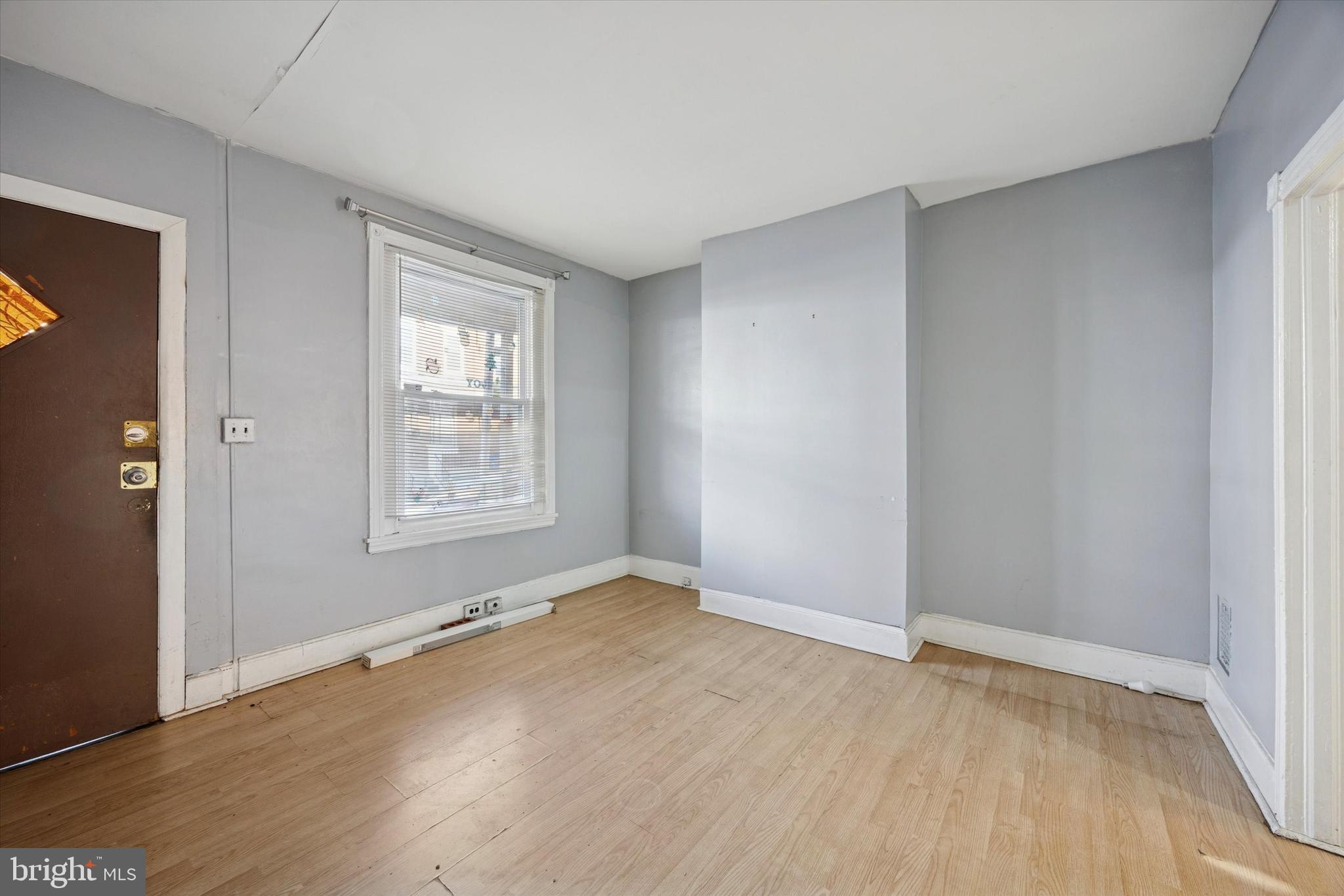 6340 Theodore Street Philadelphia, PA 19142 - Photo 3 of 15 an empty room with wooden floor and windows