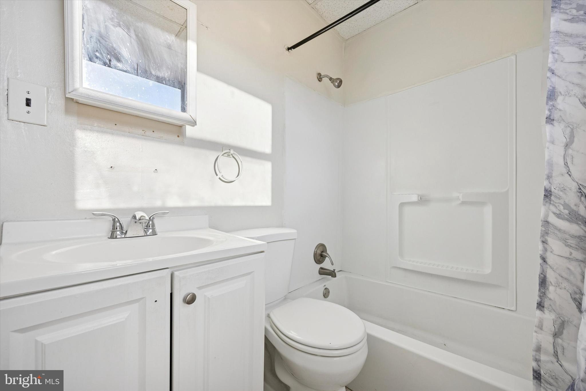 6340 Theodore Street Philadelphia, PA 19142 - Photo 10 of 15 a bathroom with a sink toilet vanity and tub