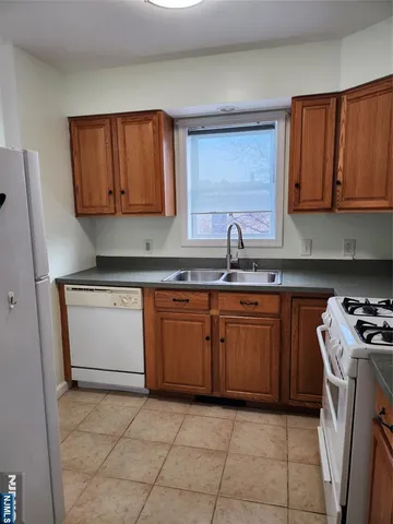 a kitchen with a sink a stove and cabinets