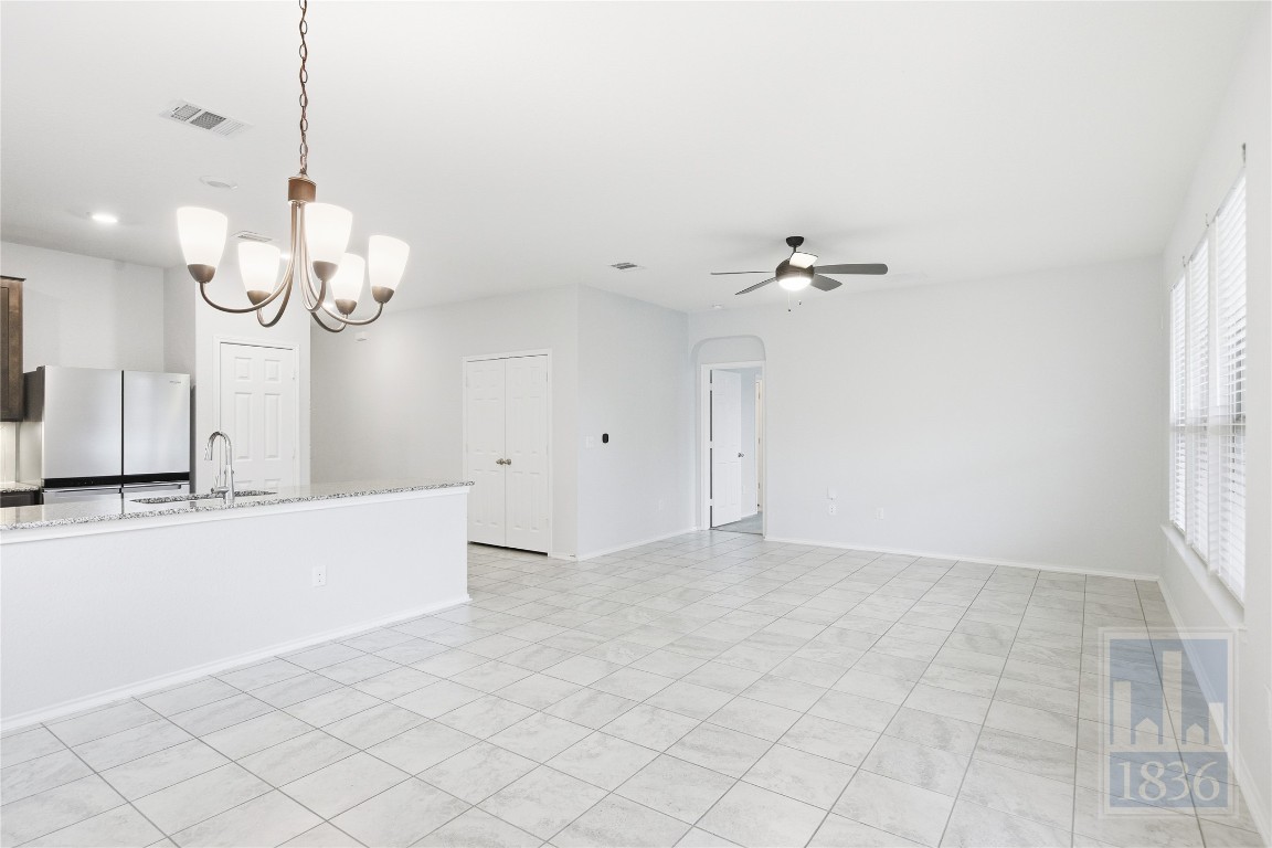 8005 Crystalbrook West Austin, TX 78724 - Photo 12 of 37 a view of a chandelier fan and wooden floor