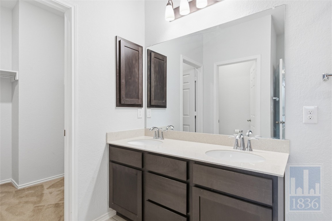 8005 Crystalbrook West Austin, TX 78724 - Photo 20 of 37 a bathroom with a double vanity sink and mirror