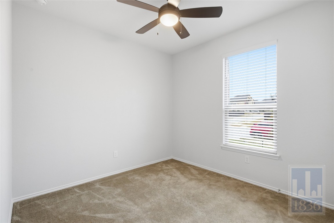 8005 Crystalbrook West Austin, TX 78724 - Photo 24 of 37 an empty room with a window and a ceiling fan
