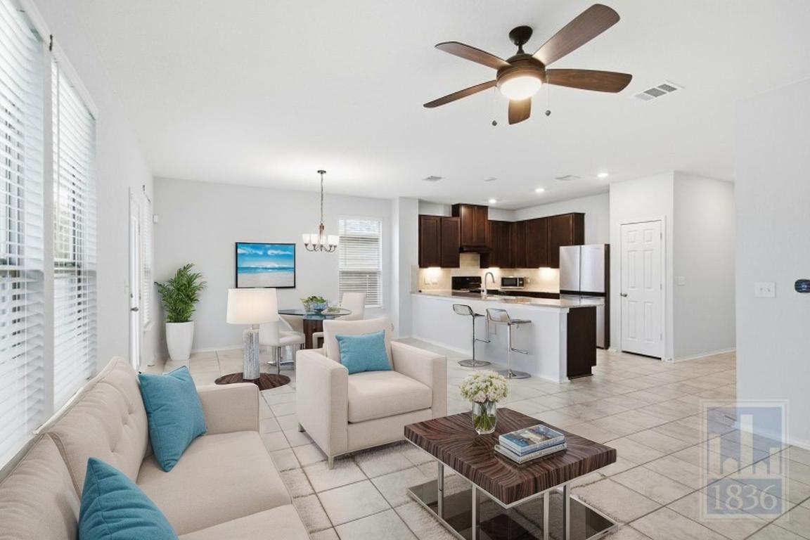 8005 Crystalbrook West Austin, TX 78724 - Photo 5 of 37 a living room with furniture kitchen view and a chandelier