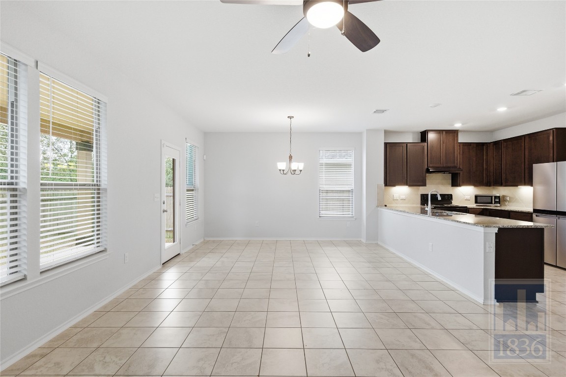 8005 Crystalbrook West Austin, TX 78724 - Photo 8 of 37 a large kitchen with cabinets and stainless steel appliances