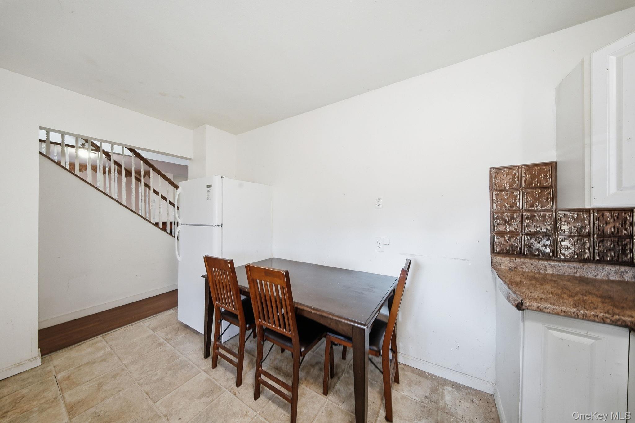 21 Ridge Street Middletown, NY 10940 - Photo 15 of 32 Dining space with stairs and light tile patterned floors