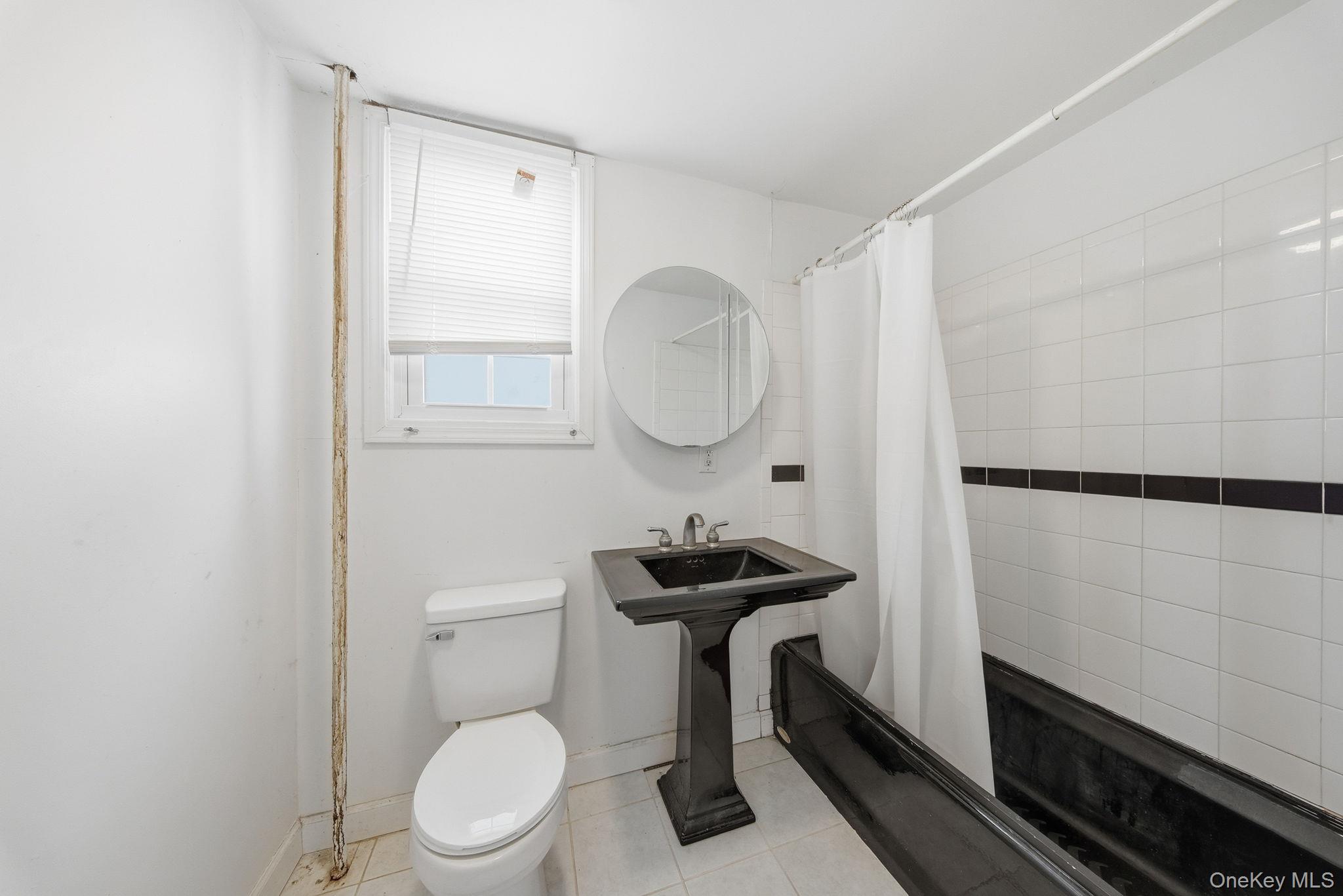 21 Ridge Street Middletown, NY 10940 - Photo 19 of 32 Full bath with shower / bath combination with curtain and light tile patterned flooring