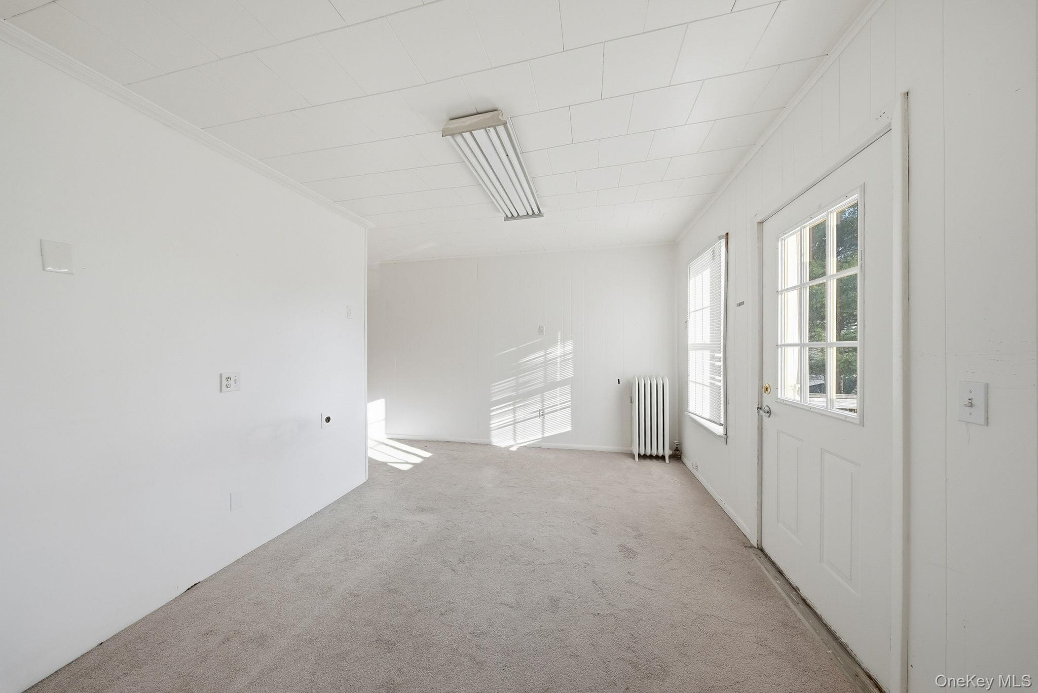 21 Ridge Street Middletown, NY 10940 - Photo 21 of 32 Carpeted bedroom with crown molding & access to back deck