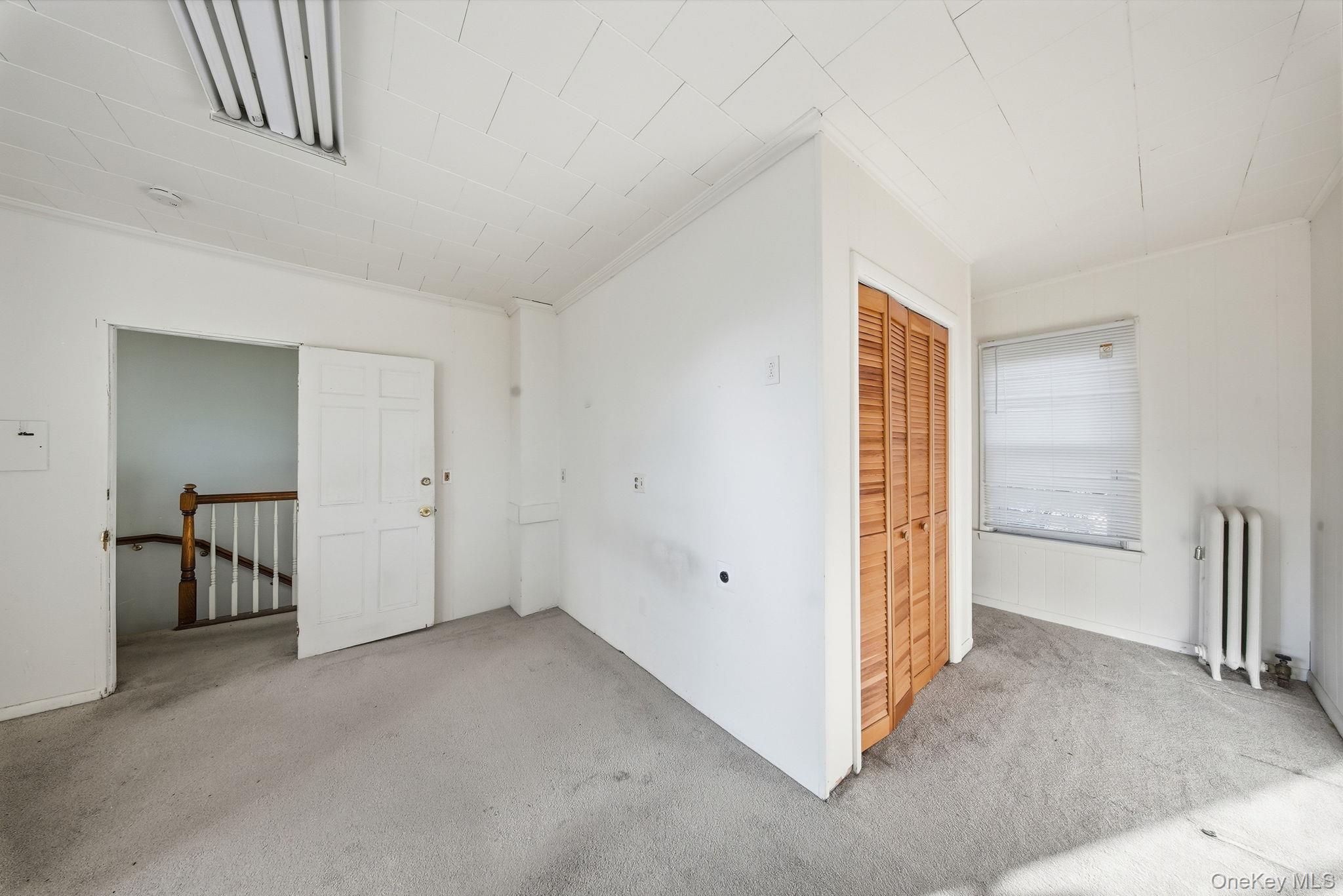 21 Ridge Street Middletown, NY 10940 - Photo 22 of 32 Carpeted bedroom with entrance to the bathroom