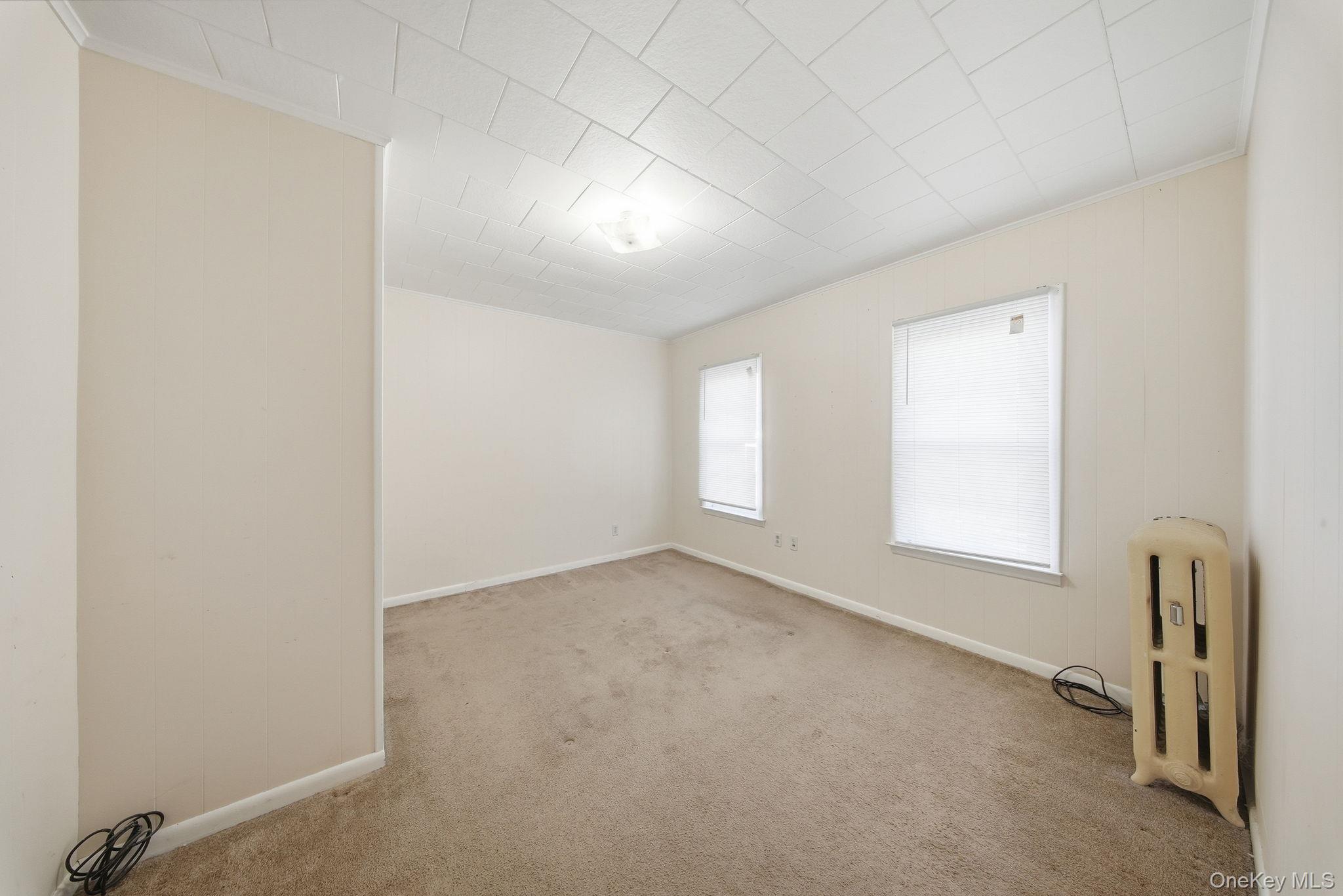 21 Ridge Street Middletown, NY 10940 - Photo 26 of 32 Carpeted beroom featuring ornamental molding and radiator