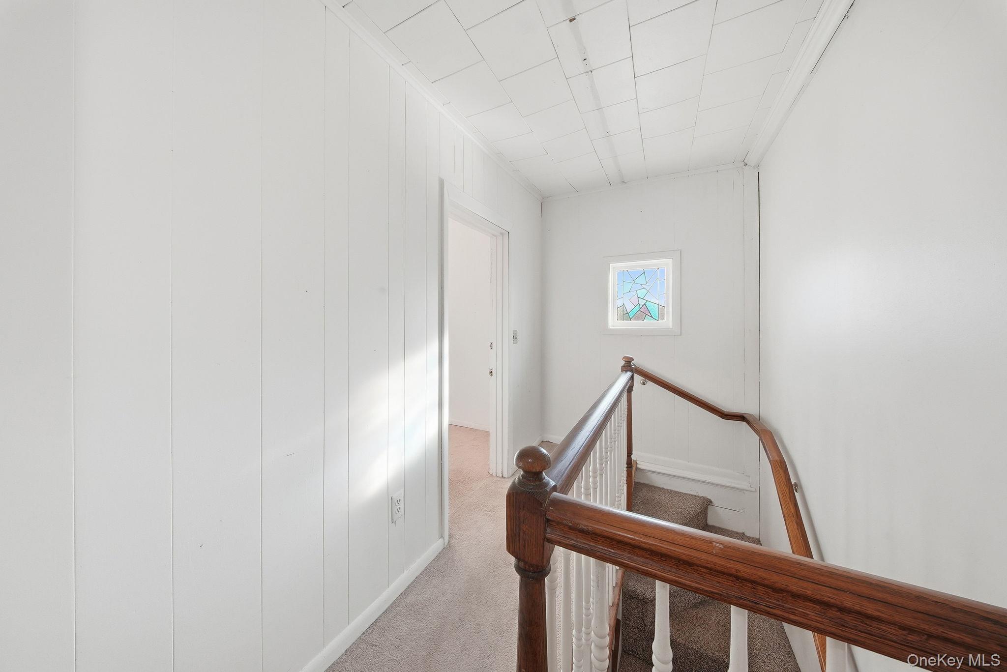 21 Ridge Street Middletown, NY 10940 - Photo 27 of 32 Corridor with carpet floors and an upstairs landing