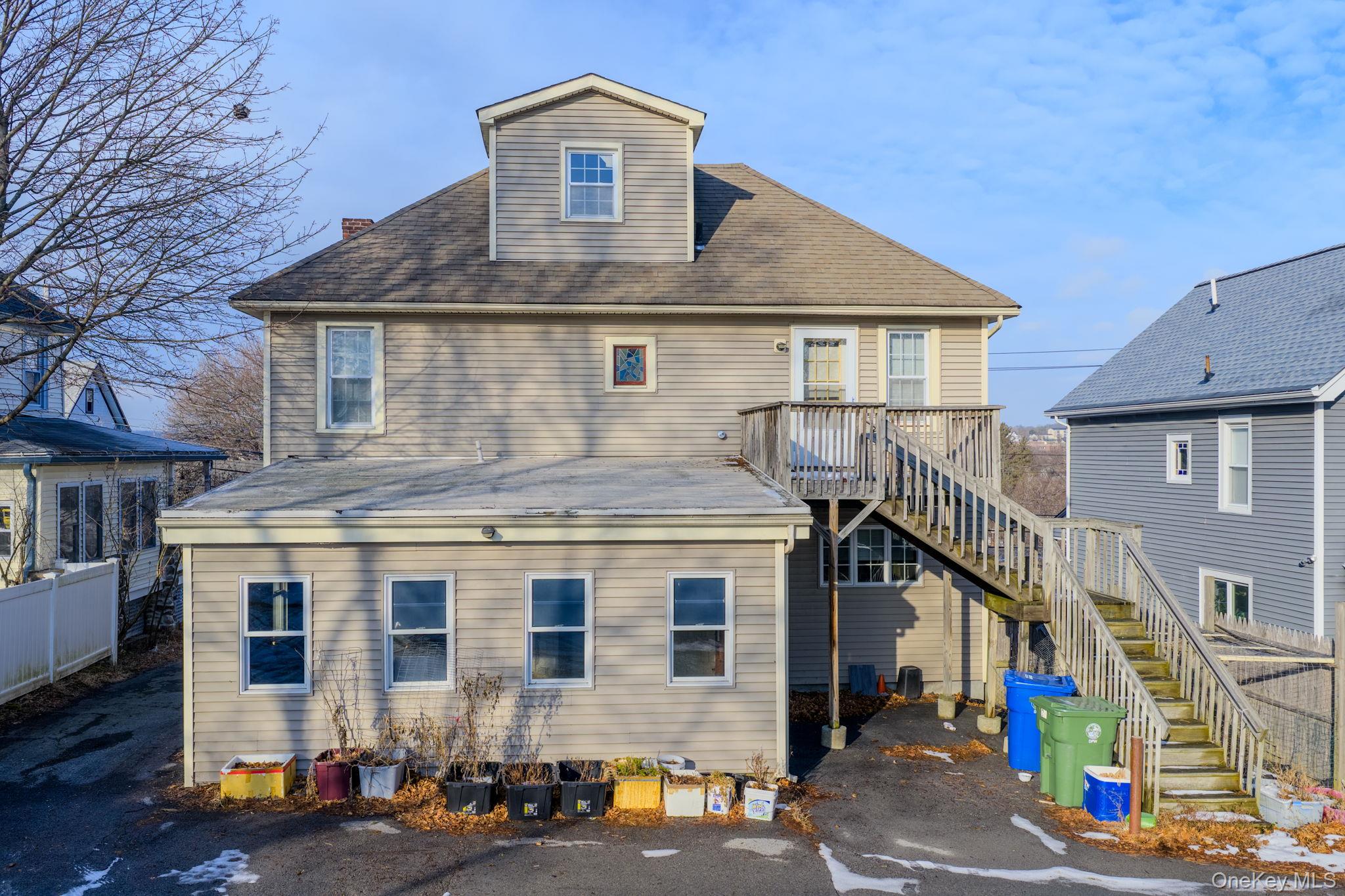21 Ridge Street Middletown, NY 10940 - Photo 30 of 32 Back of house with stairs, a shingled roof, and a deck