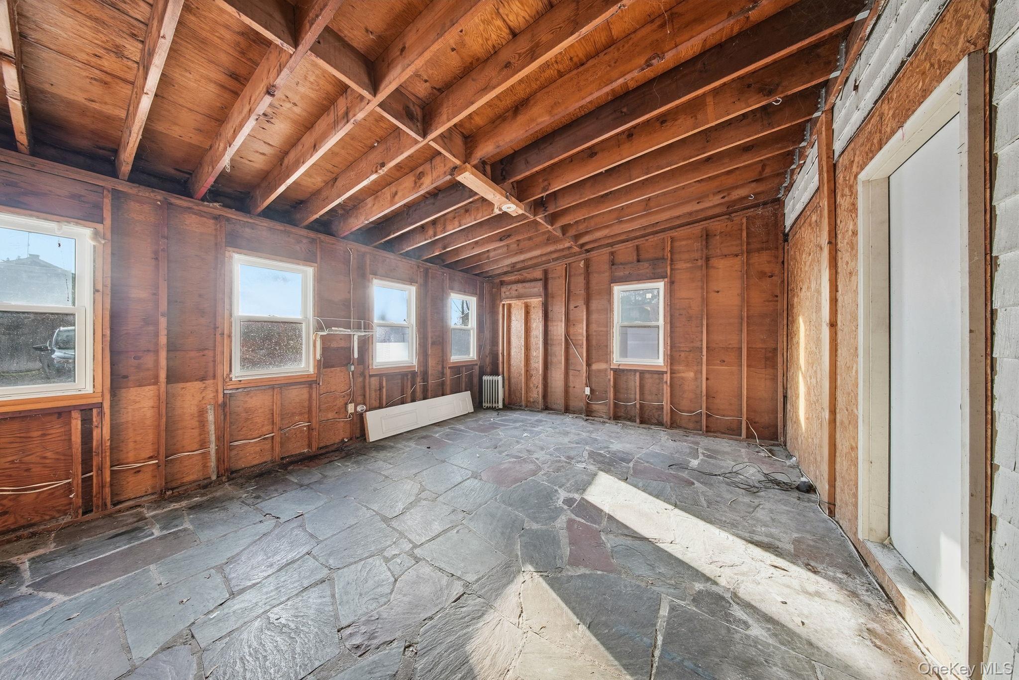 21 Ridge Street Middletown, NY 10940 - Photo 31 of 32 Misc room featuring lofted ceiling and stone floors