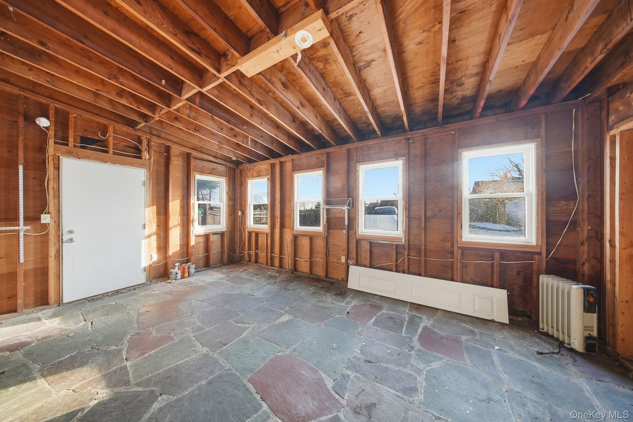 21 Ridge Street Middletown, NY 10940 - Photo 32 of 32 Misc room featuring plenty of natural light and stone flooring