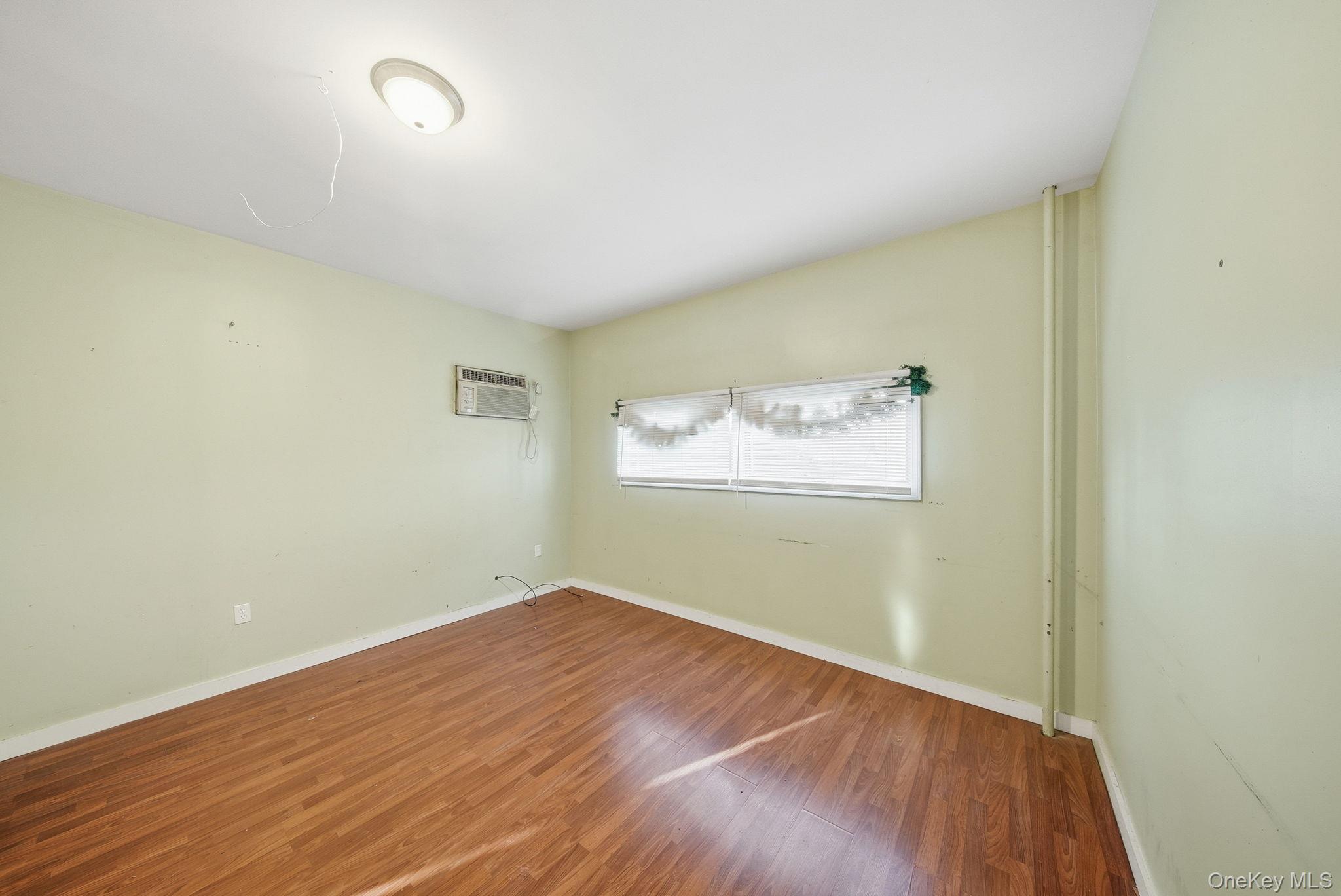 21 Ridge Street Middletown, NY 10940 - Photo 6 of 32 Spare room featuring wood finished floors and baseboards